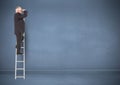 Businessman on ladder looking at a distance