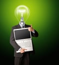 Businessman with lamp-head with open laptop Royalty Free Stock Photo