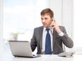 Businessman with laptop computer and phone Royalty Free Stock Photo