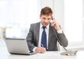 Businessman with laptop computer and phone Royalty Free Stock Photo