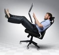 Businessman with laptop falls from an chair