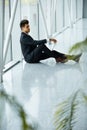 Businessman with Laptop Near the Window