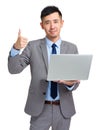 Businessman with laptop and thumb up Royalty Free Stock Photo