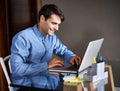 Businessman, laptop and typing in office professional, salesman and working in workplace. Male person, smile and happy Royalty Free Stock Photo