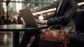 Businessman with laptop working in airport lounge