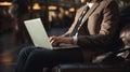 Businessman with laptop working in airport lounge