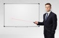 Businessman with laser pointer and copyspace white blackboard Royalty Free Stock Photo
