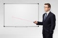 Businessman with laser pointer and copyspace white blackboard Royalty Free Stock Photo