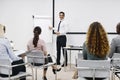 Businessman laughing during an office presentation to his staff Royalty Free Stock Photo