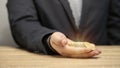 Businessman laying gold coins in hand, future financial investment money planning theory