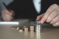 businessman laying a stack of silver coins