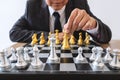 Businessman leadership playing chess and thinking strategy plan