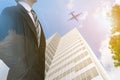 Businessman leadership wearing in a city with buildings looking at city a plane tree skyline at sunset the concept of modern Royalty Free Stock Photo