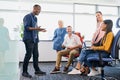 Businessman leading meeting with work colleagues in startup office