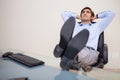 Businessman leaning back in his chair Royalty Free Stock Photo