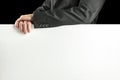 Businessman leaning on a blank white sign Royalty Free Stock Photo