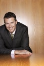 Businessman Leaning At Conference Table