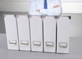 Businessman leaning on a folder in the office