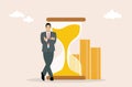 Businessman leaning on hourglass, time money concept, vector illustration Royalty Free Stock Photo