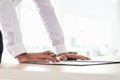 Businessman leaning on office desk to sign a document Royalty Free Stock Photo