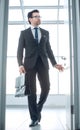 Businessman with a leather briefcase entering his client`s office. Royalty Free Stock Photo