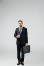 Businessman with leather suitcase and paper