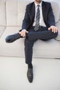 Businessman with leg on his knee