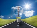 Businessman in light bulb with wind turbines and solar panels Royalty Free Stock Photo