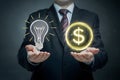 Businessman with lightbulb and glowing dollar sign, symbolizing lucrative ideas and financial success