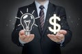 Businessman with lightbulb and glowing dollar sign, symbolizing lucrative ideas and financial success