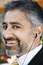 Businessman Listening Music Through Earphone