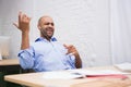 Businessman listening music while playing air guitar in office Royalty Free Stock Photo