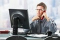 Businessman listening to landline call in office