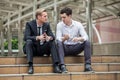 businessman listening to partner talking sitting on steps in city outdoors . team discussing.consulting client.meeting,sharing his Royalty Free Stock Photo