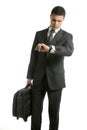 Businessman look his watch with handbag Royalty Free Stock Photo