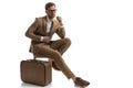 Businessman looking away, closing his jacket, sitting on a chair Royalty Free Stock Photo