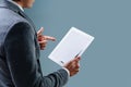 Businessman is looking at black screen of his tablet over blue background Royalty Free Stock Photo