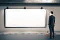 Businessman looking on blank billboard Royalty Free Stock Photo