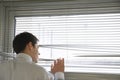 Businessman Looking Through Blinds Royalty Free Stock Photo