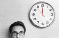 Businessman Looking At Clock On Wall In Office Royalty Free Stock Photo