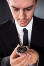 Businessman looking at a compass