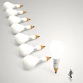 Businessman looking at 3d pencil and light bulb Royalty Free Stock Photo