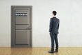 Businessman looking on door with success sign Royalty Free Stock Photo