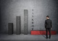 Businessman looking at fallen bar of the graph with 'bankort' word near it Royalty Free Stock Photo