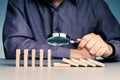 Businessman looking the falling domino