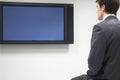 Businessman Looking At Flat Screen Television Royalty Free Stock Photo
