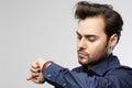 Businessman looking his watch. Isolated on a grey background Royalty Free Stock Photo