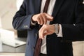 Businessman looking at his watch in office, closeup Royalty Free Stock Photo