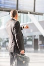 Businessman looking on his watch while waiting for boarding in airport Royalty Free Stock Photo