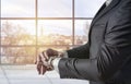 Businessman looking at his watch and watching the time in the office Royalty Free Stock Photo